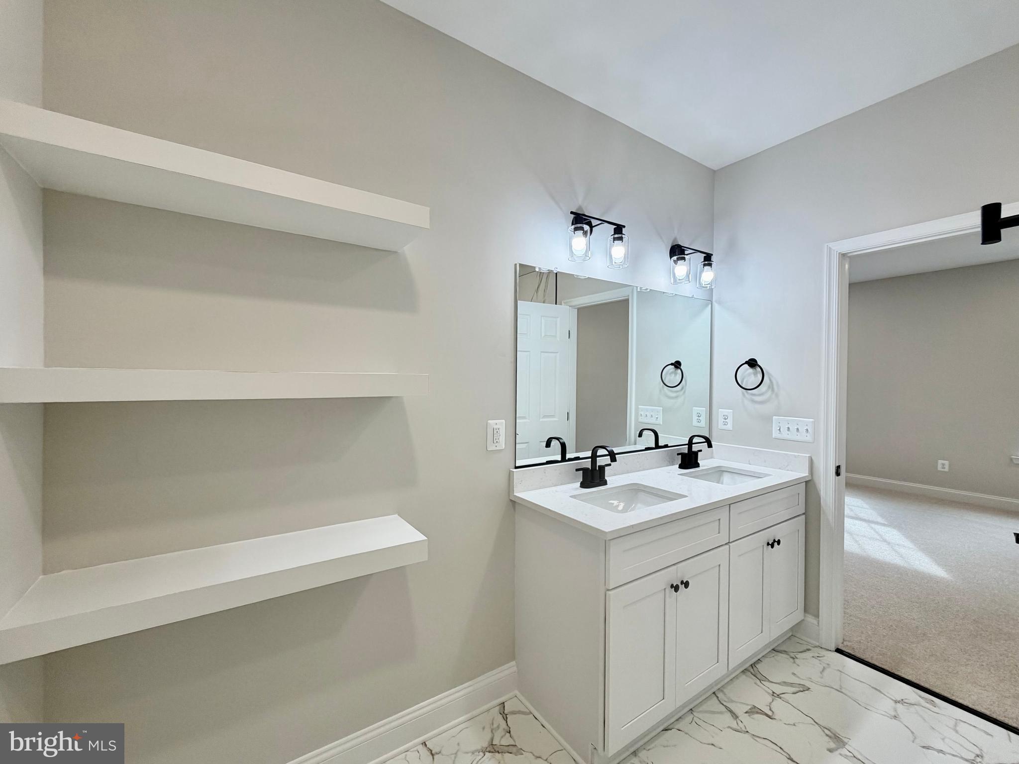44968 Hewitt Road Callaway, MD 20620 - Photo 9 of 33 a bathroom with a sink a mirror and a toilet