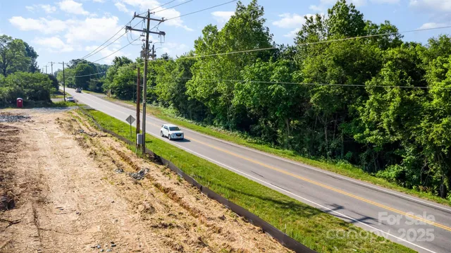 a view of a yard with potted plants