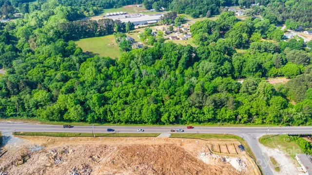 a view of a swimming pool and a yard