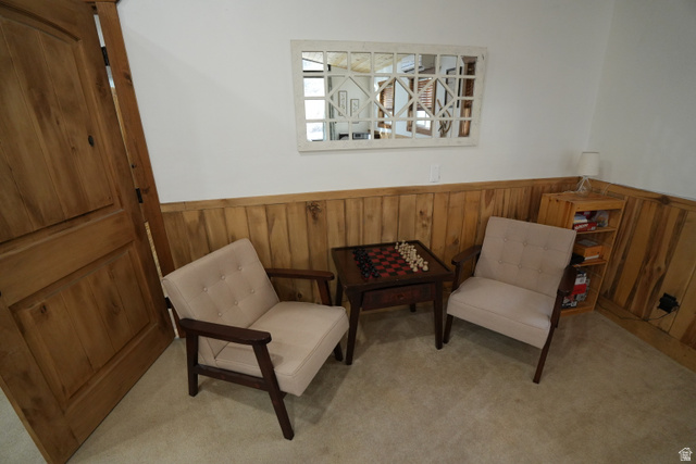 3711 North Canyon Road Provo, UT 84604 - Photo 25 of 42 Sitting room featuring wainscoting, wooden walls, and light colored carpet