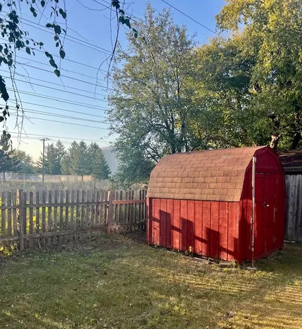 a view of a yard with large trees
