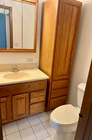 a bathroom with a toilet a sink and a mirror
