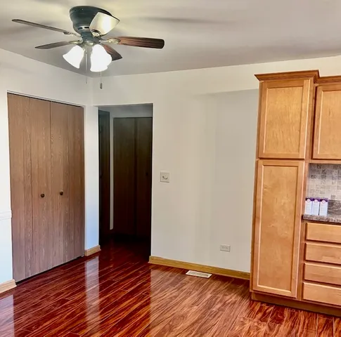 a view of room with hardwood floor and ceiling fan