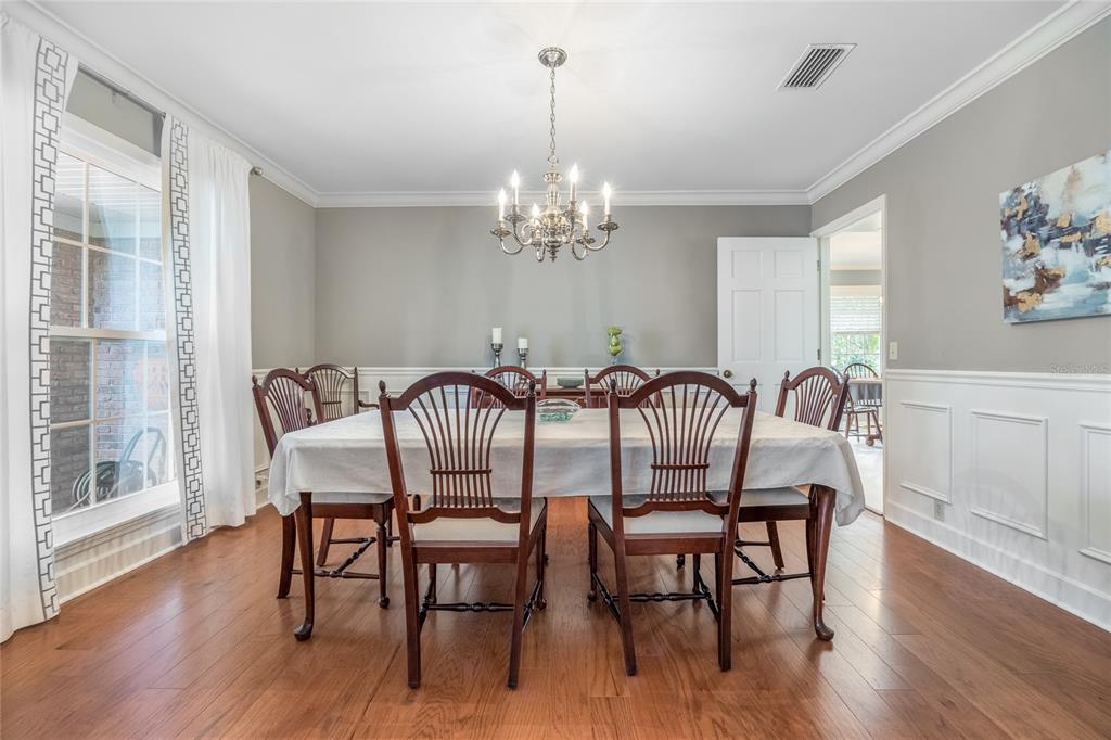 5808 Southwest 35th Way Gainesville, FL 32608 - Photo 12 of 54 a view of a dining room with furniture wooden floor and chandelier