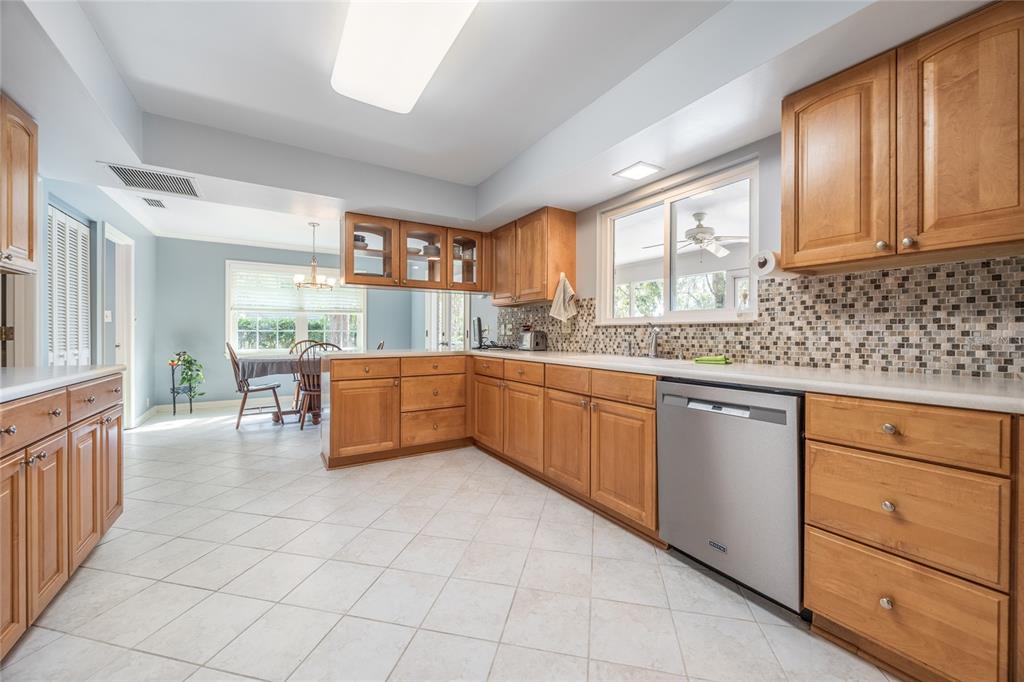 5808 Southwest 35th Way Gainesville, FL 32608 - Photo 14 of 54 a kitchen with stainless steel appliances granite countertop a stove a sink and a refrigerator