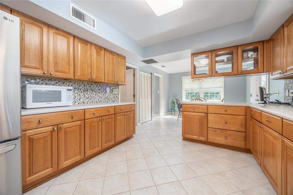5808 Southwest 35th Way Gainesville, FL 32608 - Photo 15 of 54 a kitchen with granite countertop a sink window and cabinets
