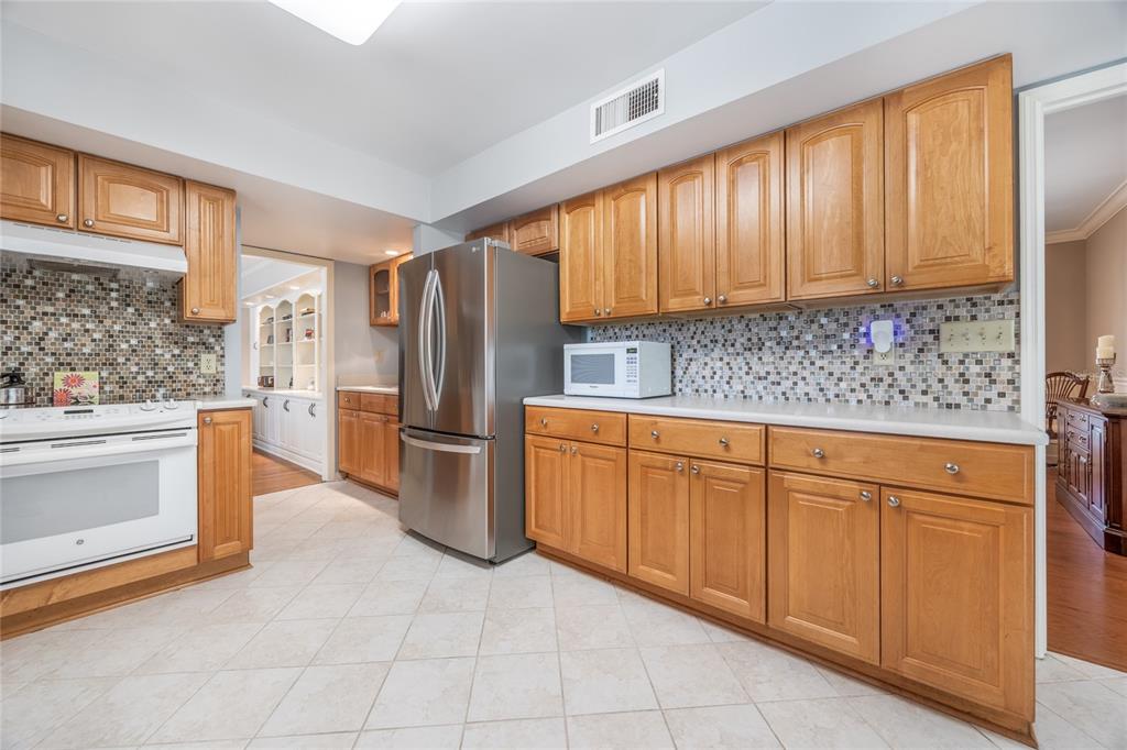 5808 Southwest 35th Way Gainesville, FL 32608 - Photo 16 of 54 a kitchen with stainless steel appliances granite countertop a stove a sink and a refrigerator