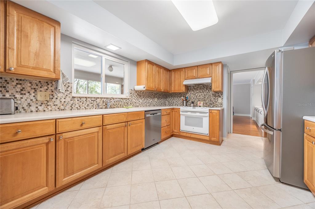 5808 Southwest 35th Way Gainesville, FL 32608 - Photo 17 of 54 a kitchen with stainless steel appliances granite countertop a stove a sink and a refrigerator