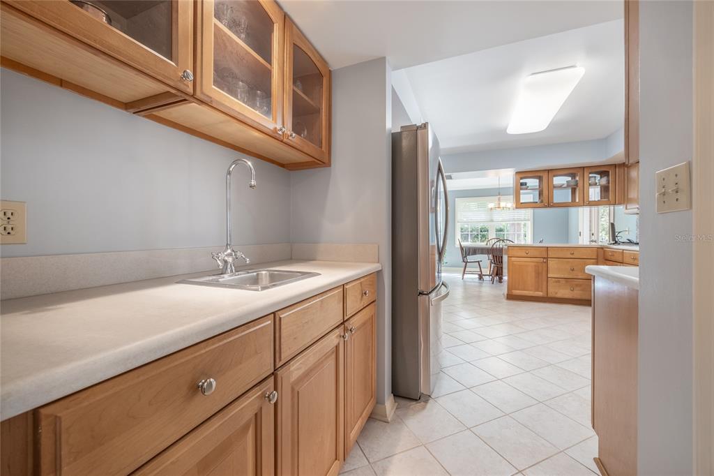 5808 Southwest 35th Way Gainesville, FL 32608 - Photo 18 of 54 a kitchen with a sink and a refrigerator