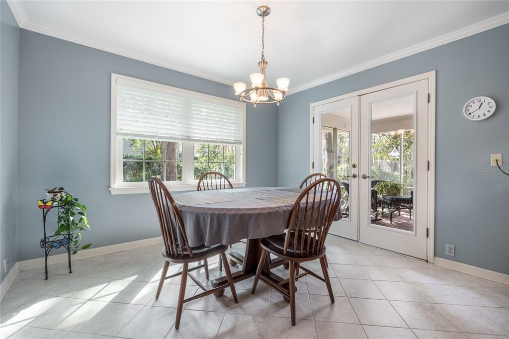 5808 Southwest 35th Way Gainesville, FL 32608 - Photo 19 of 54 a dining room with furniture a chandelier and wooden floor