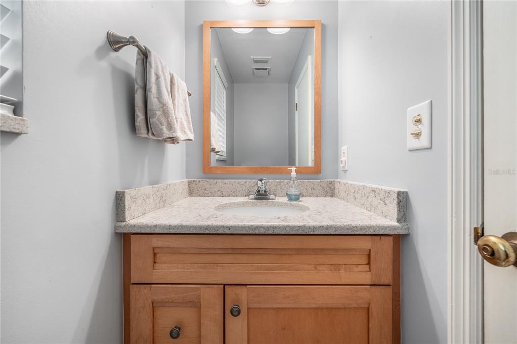 5808 Southwest 35th Way Gainesville, FL 32608 - Photo 20 of 54 a bathroom with a granite countertop sink and a mirror