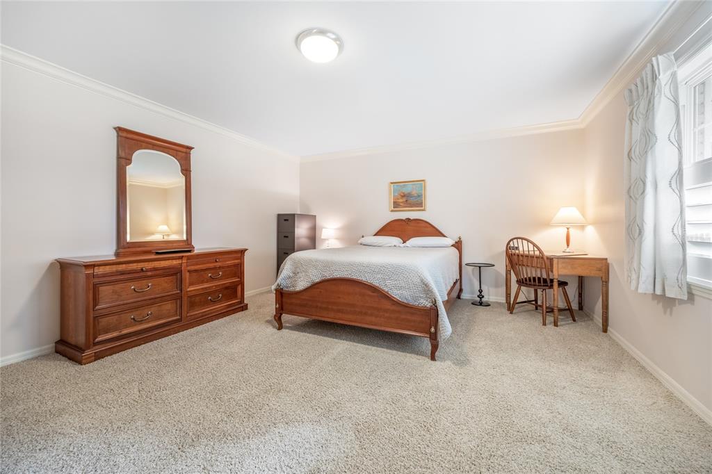 5808 Southwest 35th Way Gainesville, FL 32608 - Photo 23 of 54 a bedroom with a bed and a table in it