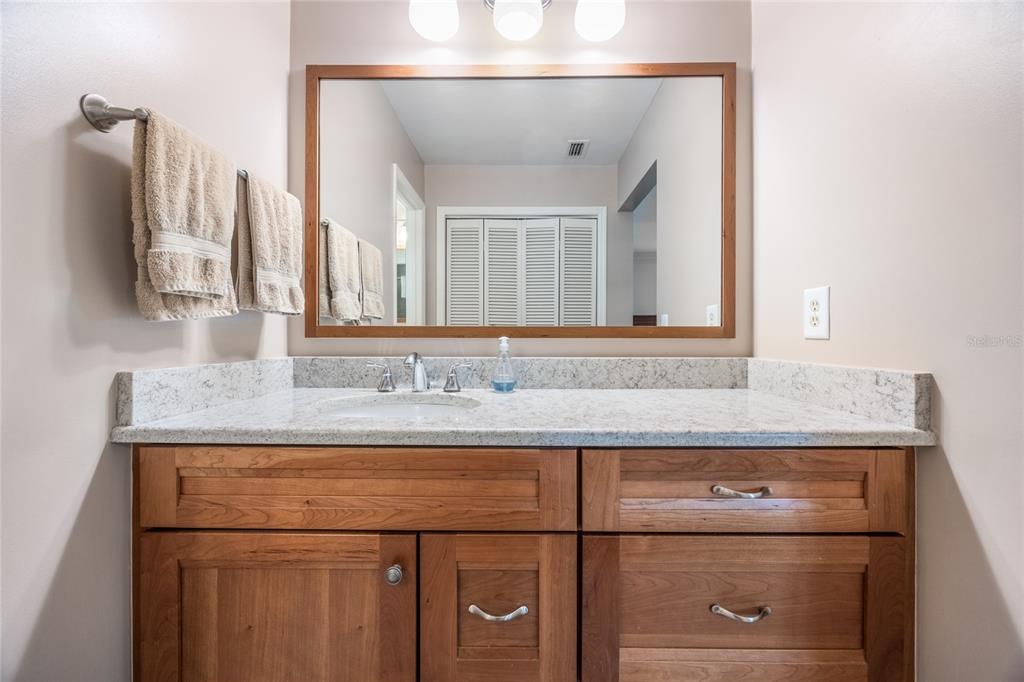 5808 Southwest 35th Way Gainesville, FL 32608 - Photo 26 of 54 a bathroom with a granite countertop sink and a mirror