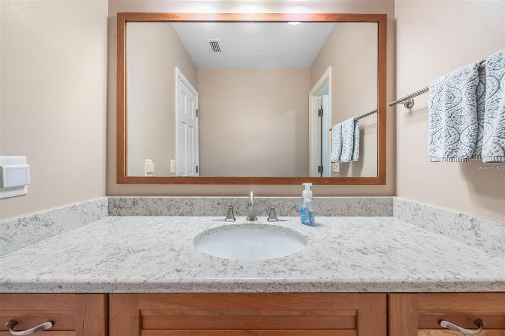 5808 Southwest 35th Way Gainesville, FL 32608 - Photo 34 of 54 a bathroom with a granite countertop sink and a mirror