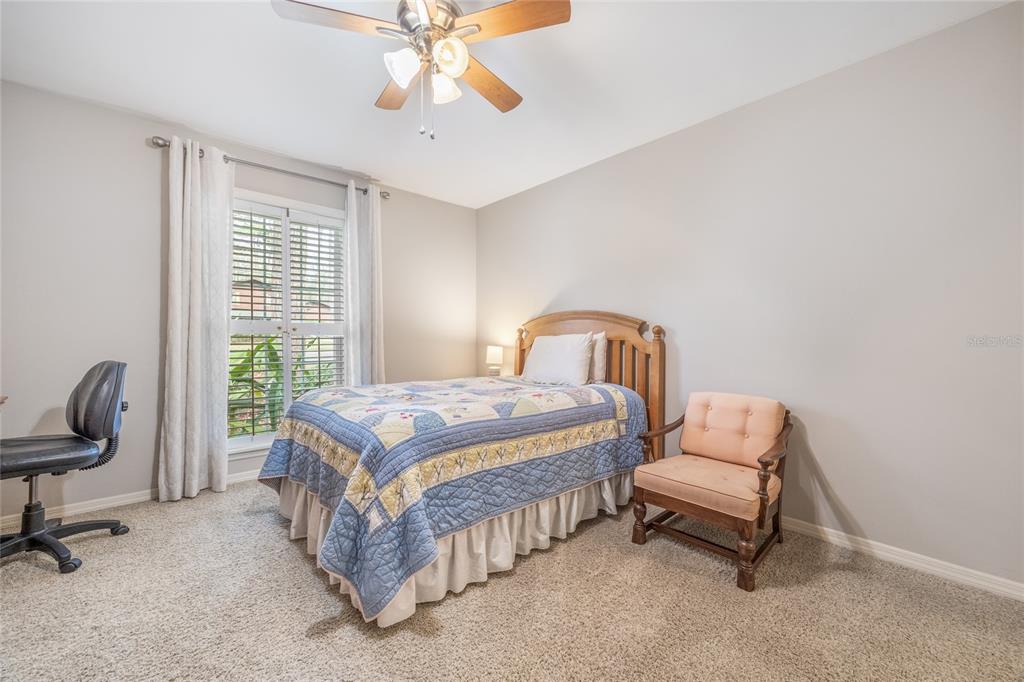 5808 Southwest 35th Way Gainesville, FL 32608 - Photo 36 of 54 a bedroom with a bed chair and a window