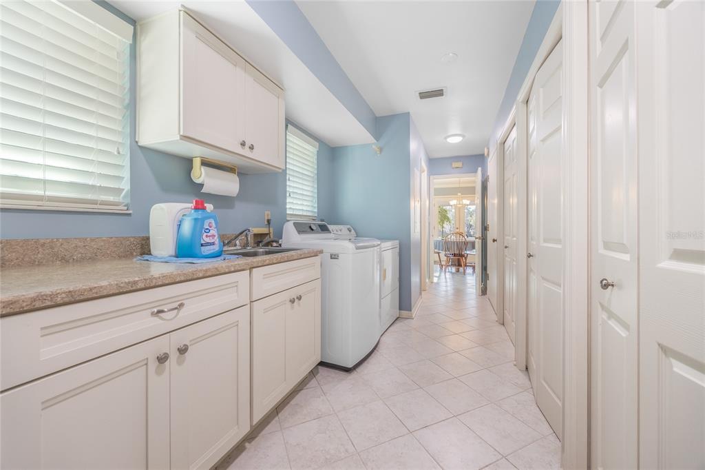 5808 Southwest 35th Way Gainesville, FL 32608 - Photo 39 of 54 a kitchen with white cabinets and sink