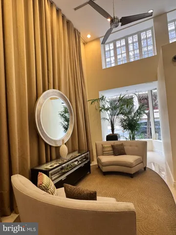 a living room with a couch a fireplace and a large window