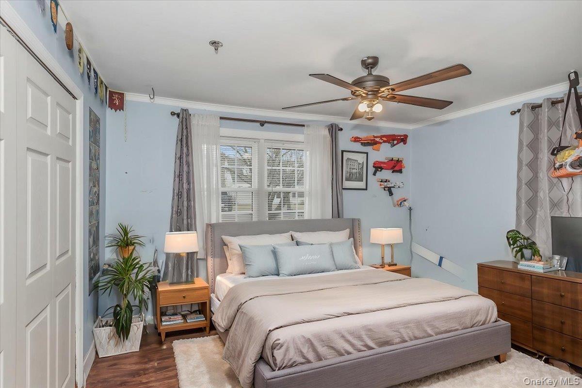 86 Oceanview Avenue Valley Stream, NY 11581 - Photo 11 of 21 a bedroom with a bed and a chandelier