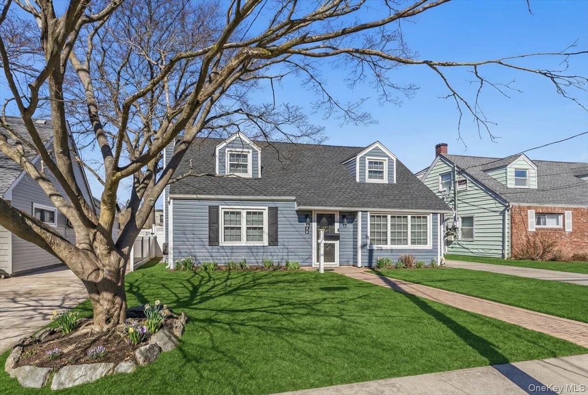 86 Oceanview Avenue Valley Stream, NY 11581 - Photo 2 of 21 a front view of a house with a yard