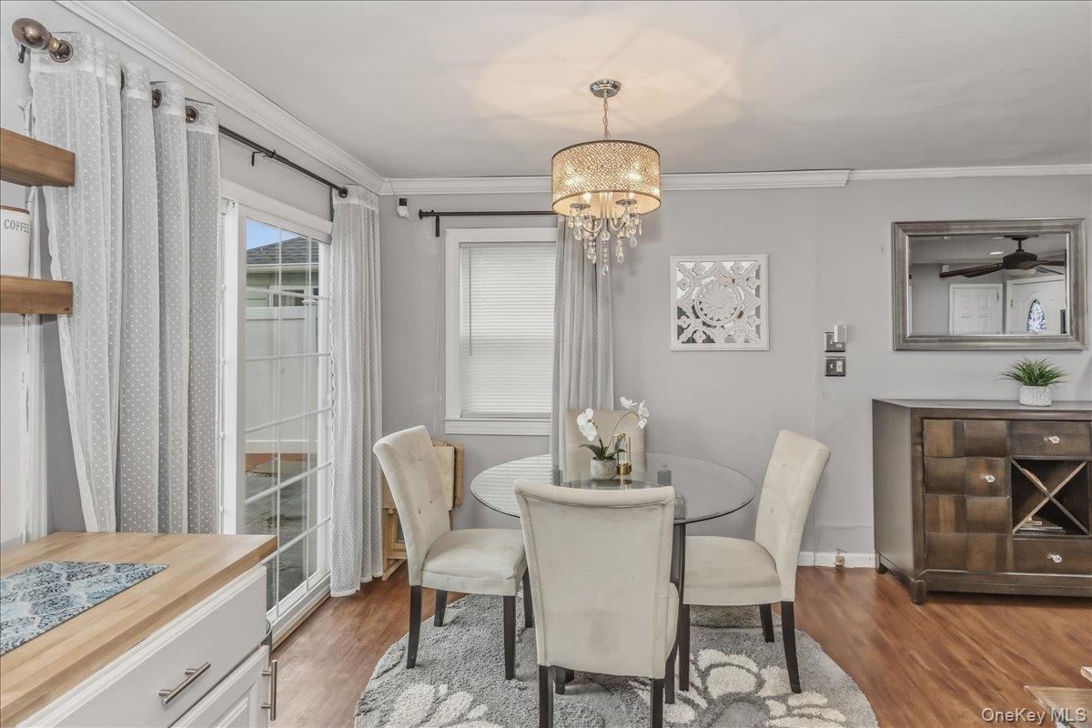 86 Oceanview Avenue Valley Stream, NY 11581 - Photo 6 of 21 a view of a dining room with furniture wooden floor and chandelier