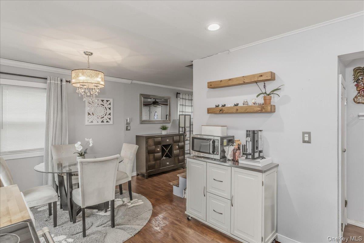 86 Oceanview Avenue Valley Stream, NY 11581 - Photo 7 of 21 a kitchen with cabinets and chairs
