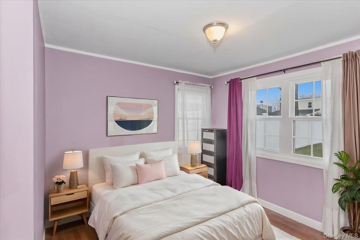 86 Oceanview Avenue Valley Stream, NY 11581 - Photo 10 of 21 a bedroom with a bed and a potted plant