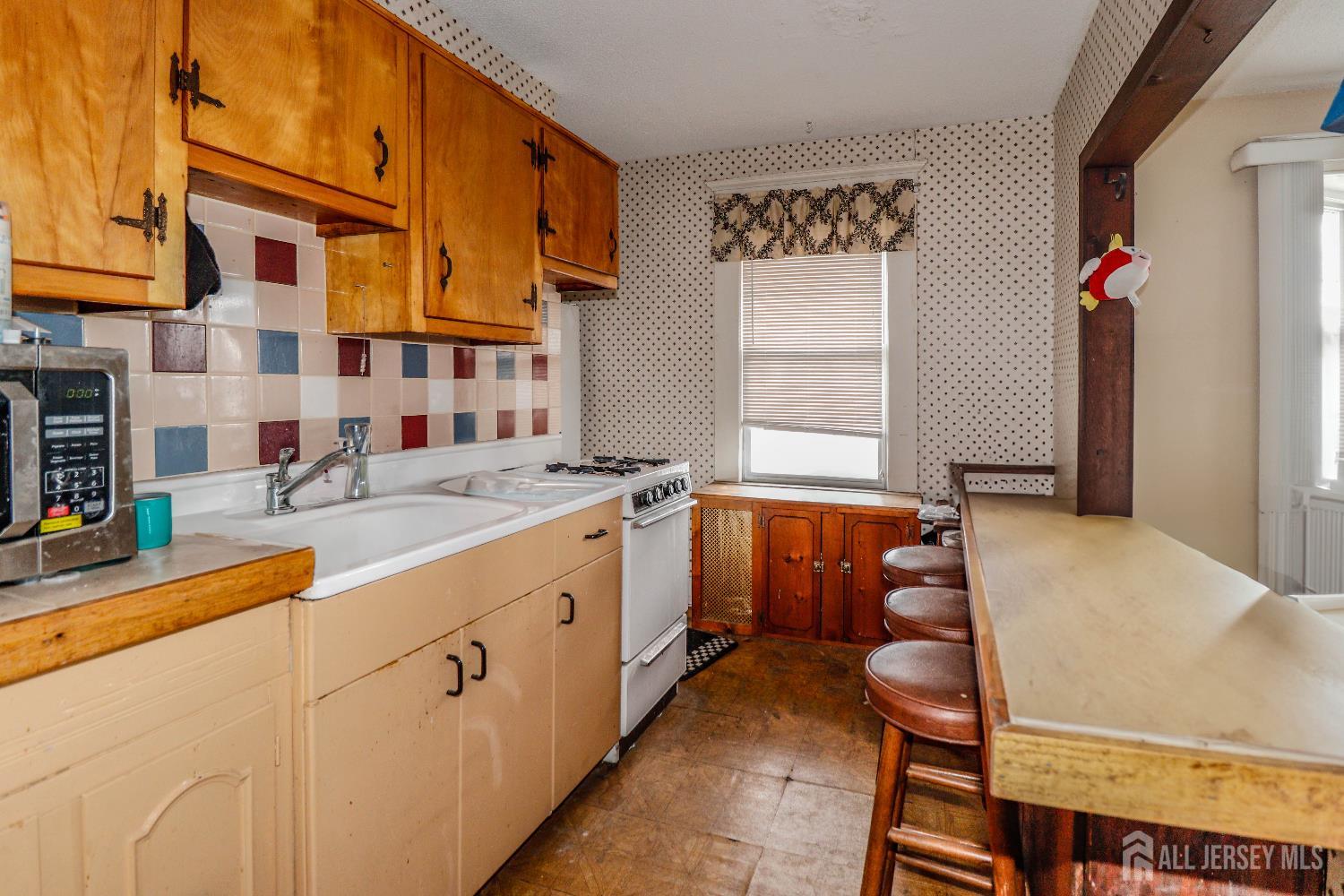 484 Old Post Road Edison, NJ 08817 - Photo 14 of 19 a kitchen with stainless steel appliances granite countertop a sink and cabinets