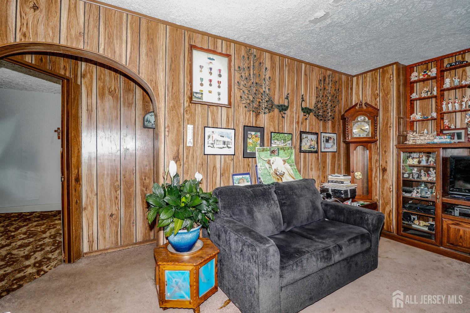 484 Old Post Road Edison, NJ 08817 - Photo 9 of 19 a living room with furniture a bookshelf and a window