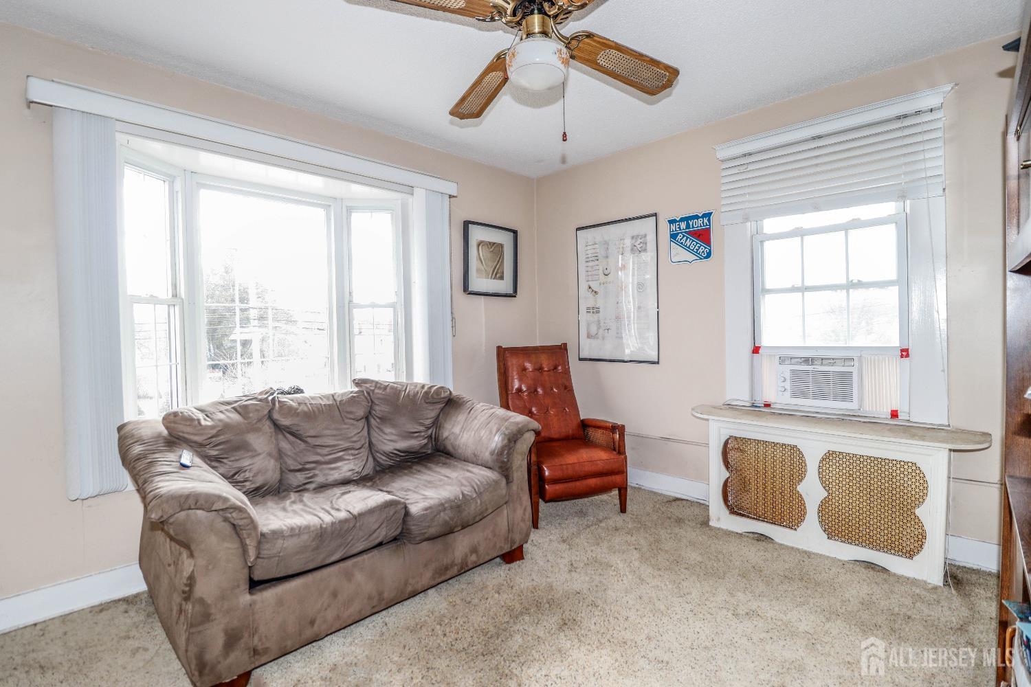 484 Old Post Road Edison, NJ 08817 - Photo 10 of 19 a living room with furniture and a window