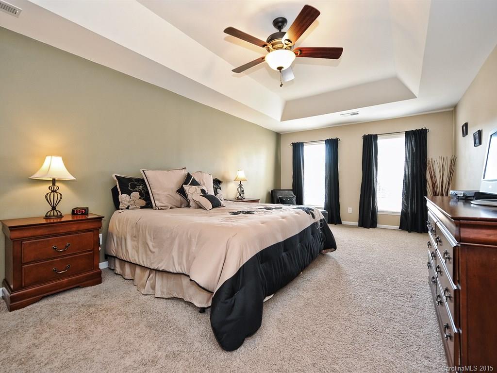 1953 Faison Avenue Fort Mill, SC 29708 - Photo 14 of 24 a spacious bedroom with a bed and a chandelier