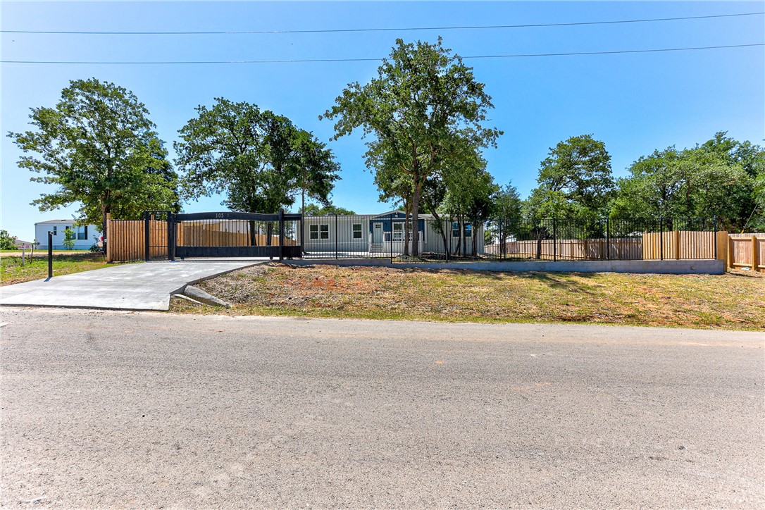 105 Soledad Street Elgin, TX 78621 - Photo 1 of 1 a view of swimming pool with outdoor seating and yard