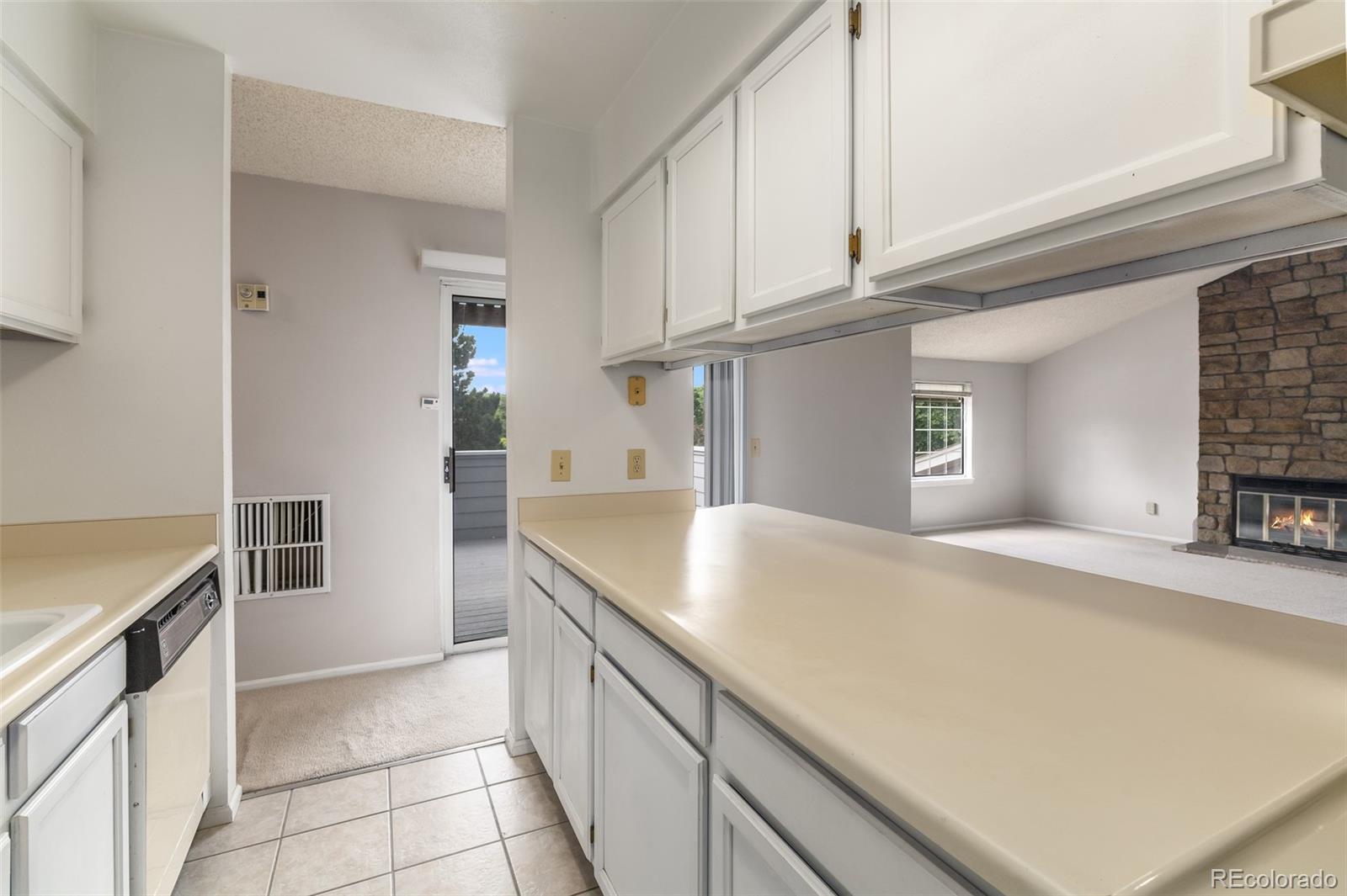 8449 Everett Way, Unit E Arvada, CO 80005 - Photo 11 of 25 a kitchen with stainless steel appliances a sink and a refrigerator