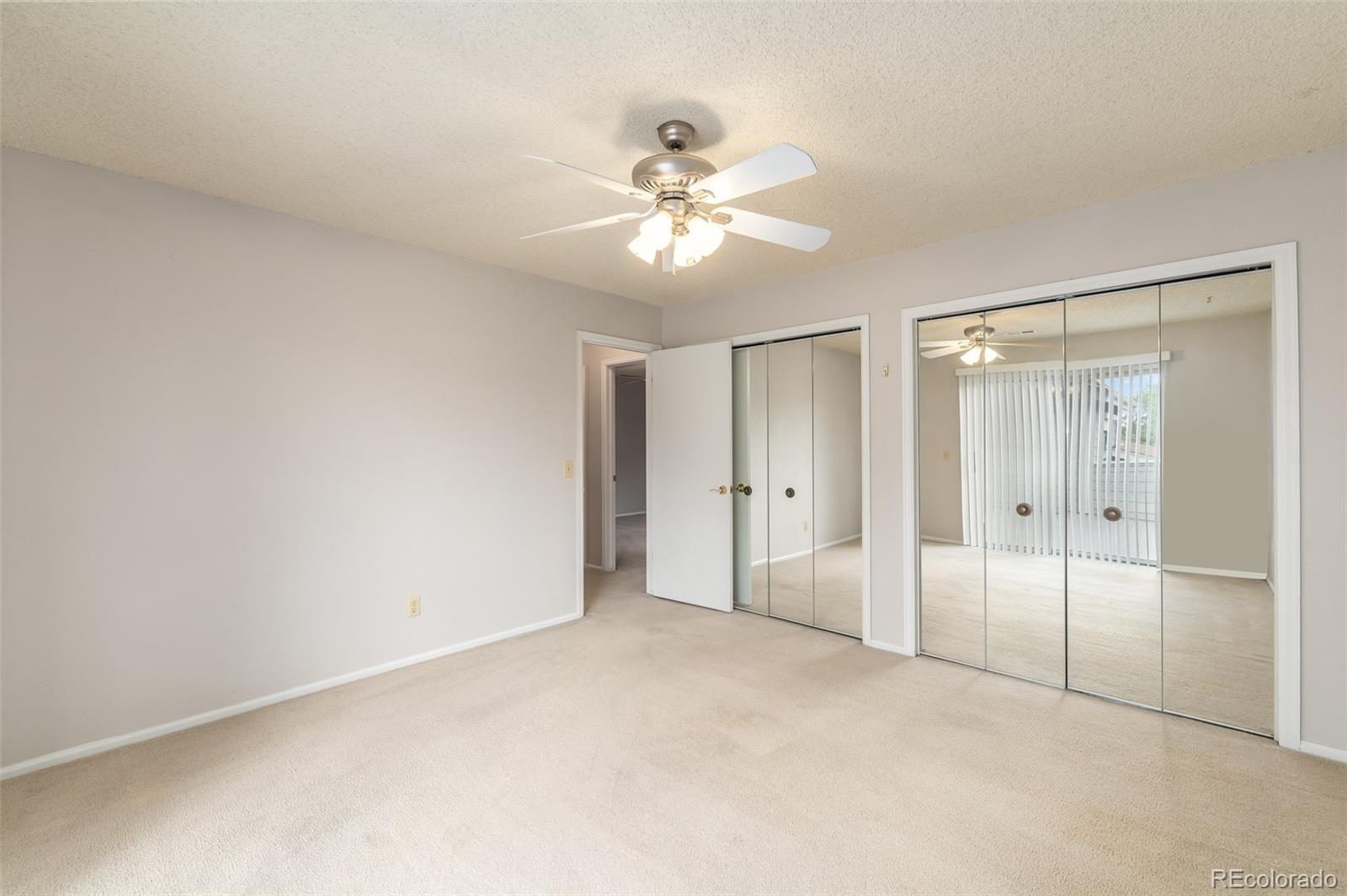 8449 Everett Way, Unit E Arvada, CO 80005 - Photo 15 of 25 a view of an empty room and a ceiling fan
