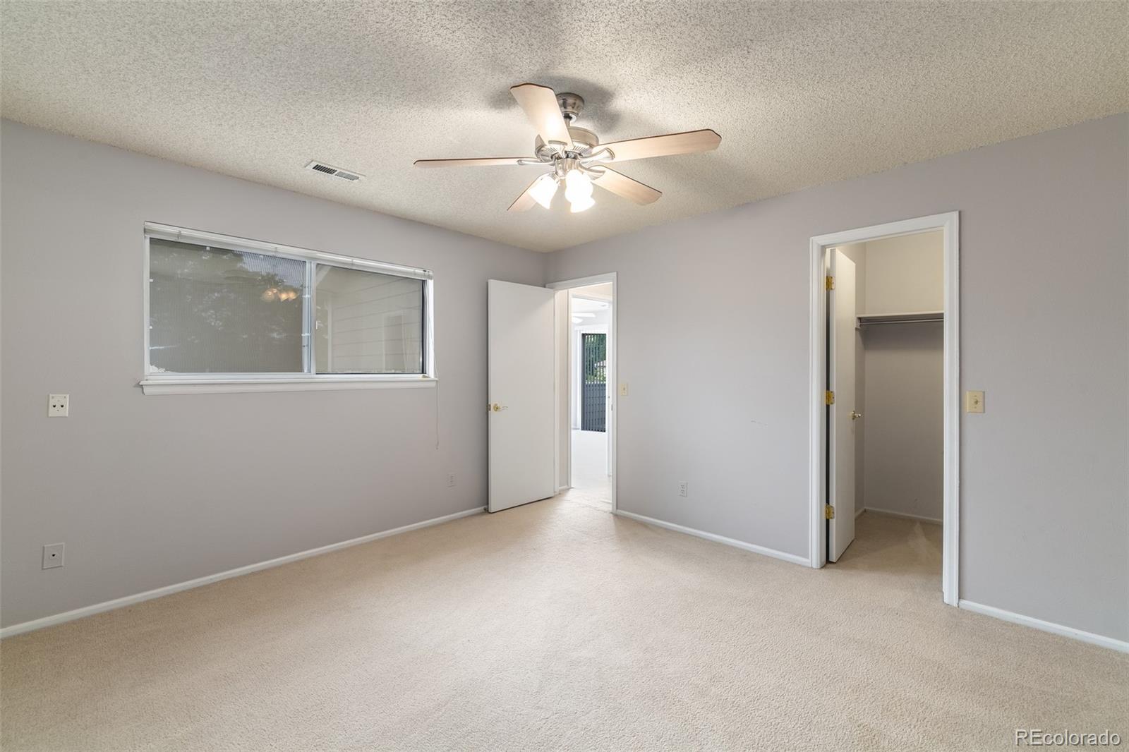 8449 Everett Way, Unit E Arvada, CO 80005 - Photo 17 of 25 an empty room with fan and windows