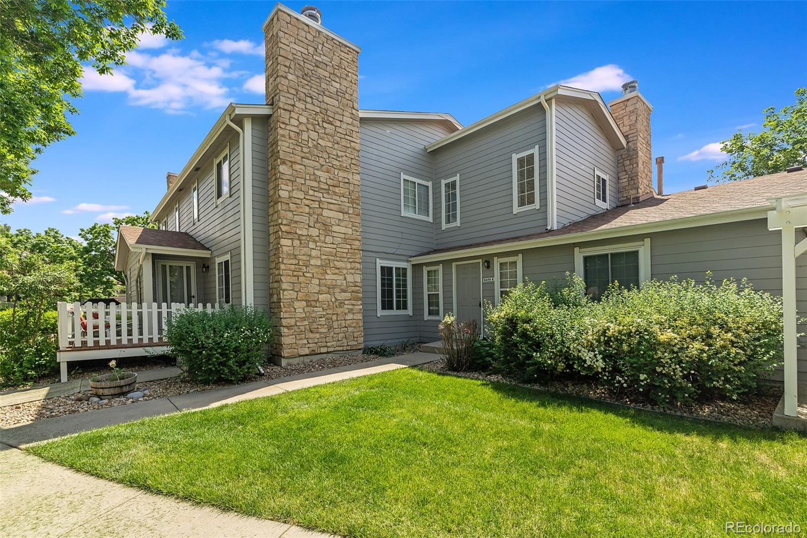 8449 Everett Way, Unit E Arvada, CO 80005 - Photo 2 of 25 a front view of a house with garden