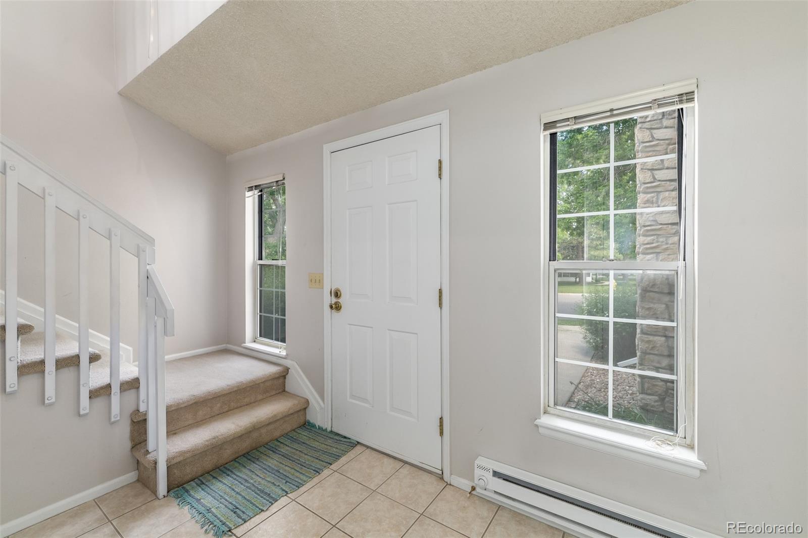 8449 Everett Way, Unit E Arvada, CO 80005 - Photo 4 of 25 a view of a room that has a large window and wooden floor