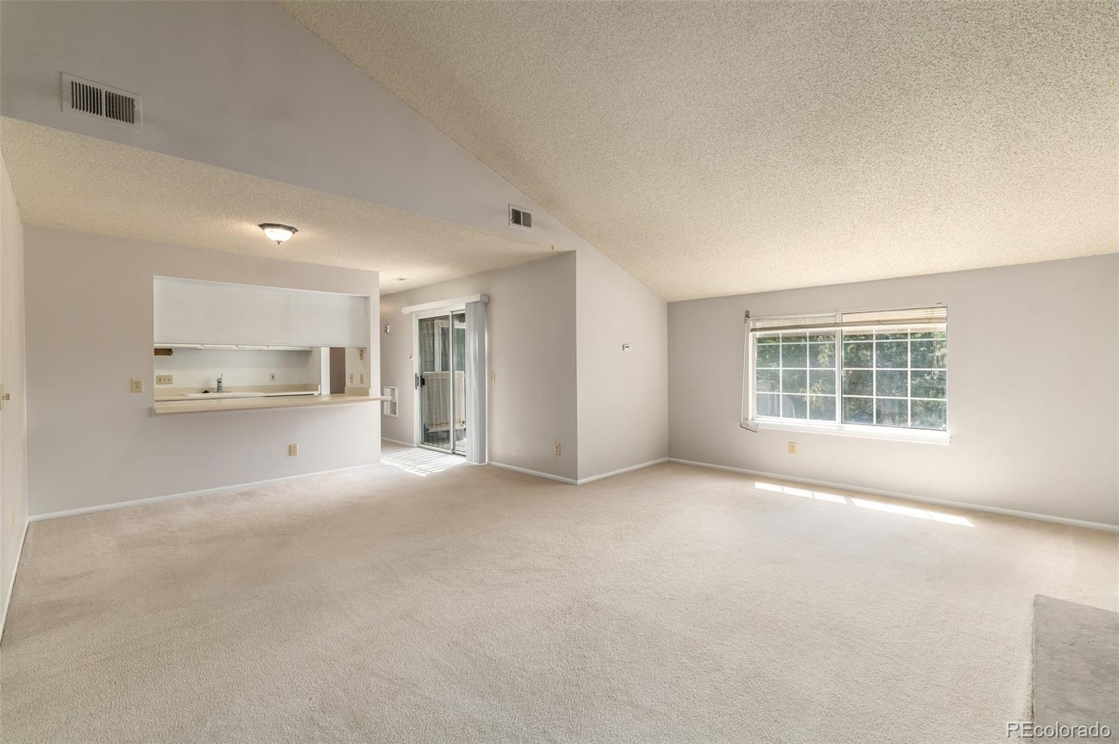 8449 Everett Way, Unit E Arvada, CO 80005 - Photo 8 of 25 a view of an empty room with a window