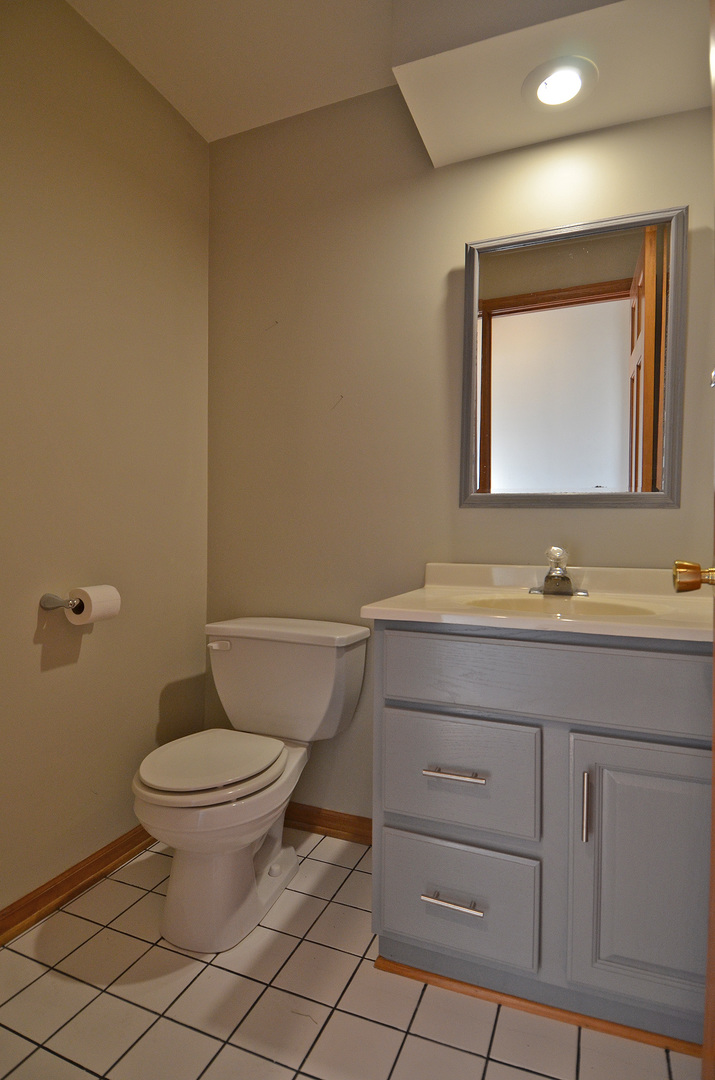 3618 East 1769th Road Ottawa, IL 61350 - Photo 15 of 36 a bathroom with a granite countertop toilet sink and mirror
