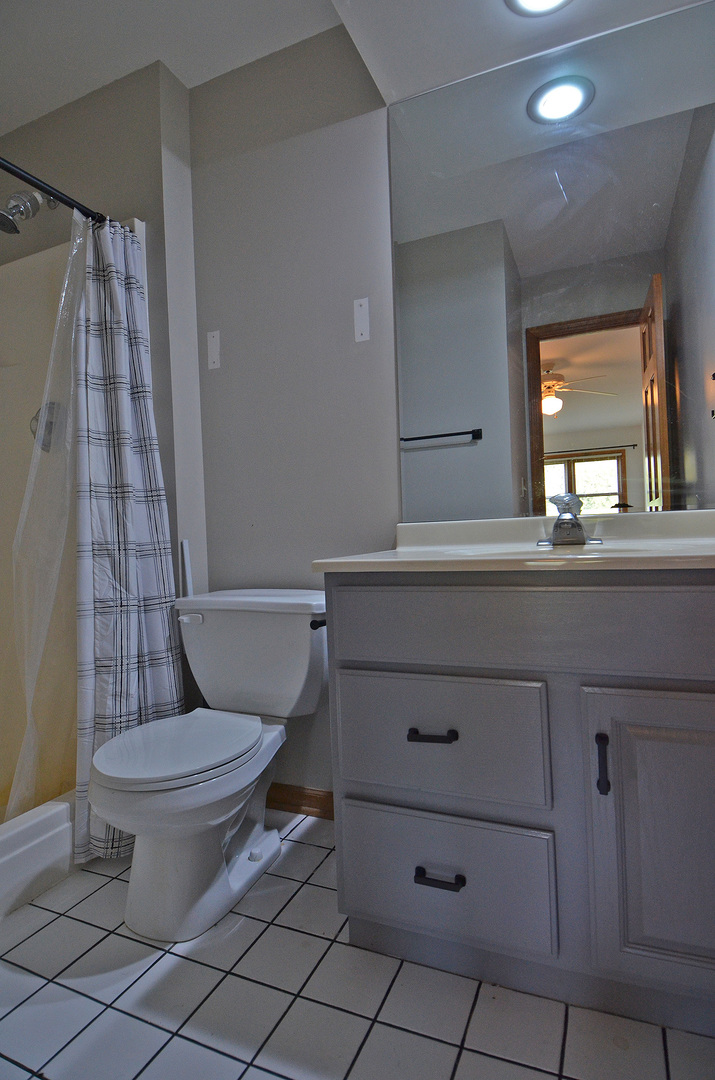 3618 East 1769th Road Ottawa, IL 61350 - Photo 29 of 36 a bathroom with a toilet a sink and a mirror