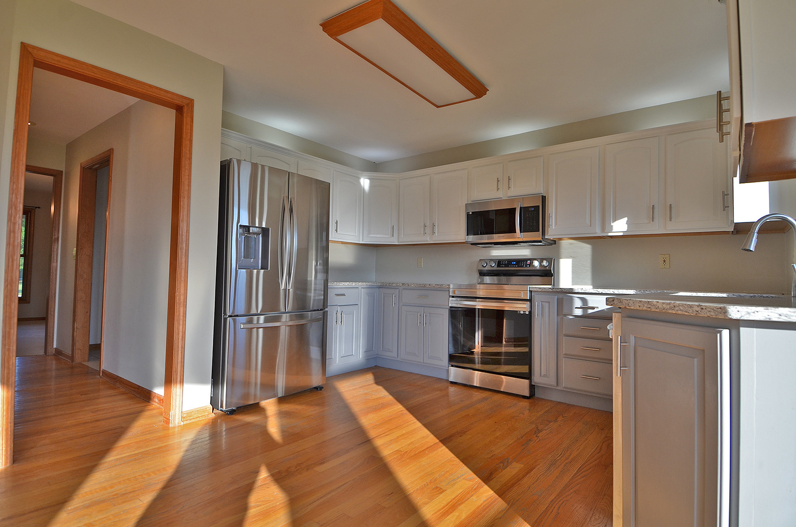 3618 East 1769th Road Ottawa, IL 61350 - Photo 8 of 36 a kitchen with granite countertop a refrigerator and a stove top oven