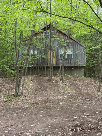 a backyard of a house with chairs