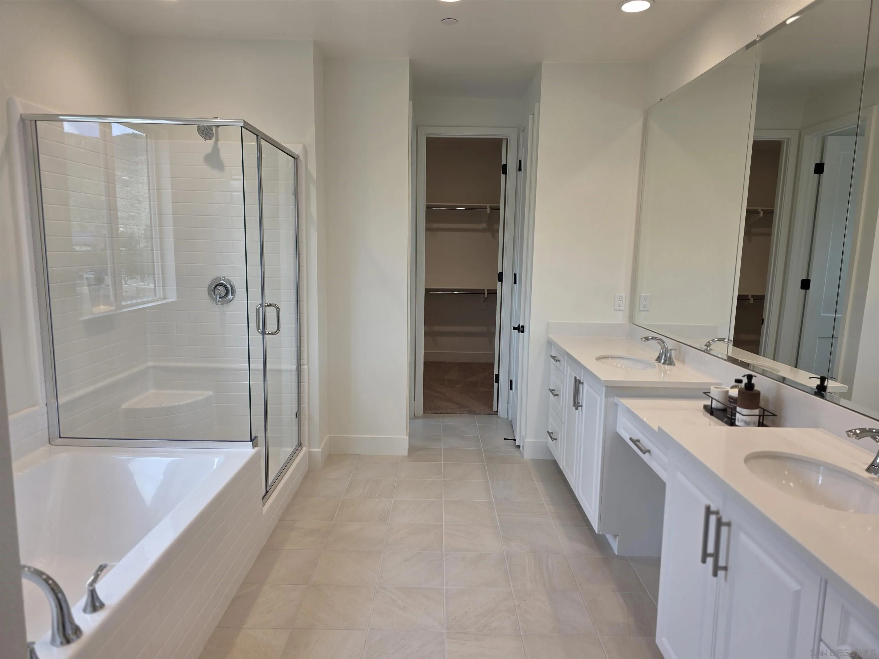 3140 Smith Place Escondido, CA 92027 - Photo 18 of 19 a bathroom with a double vanity sink a mirror a bathtub and shower