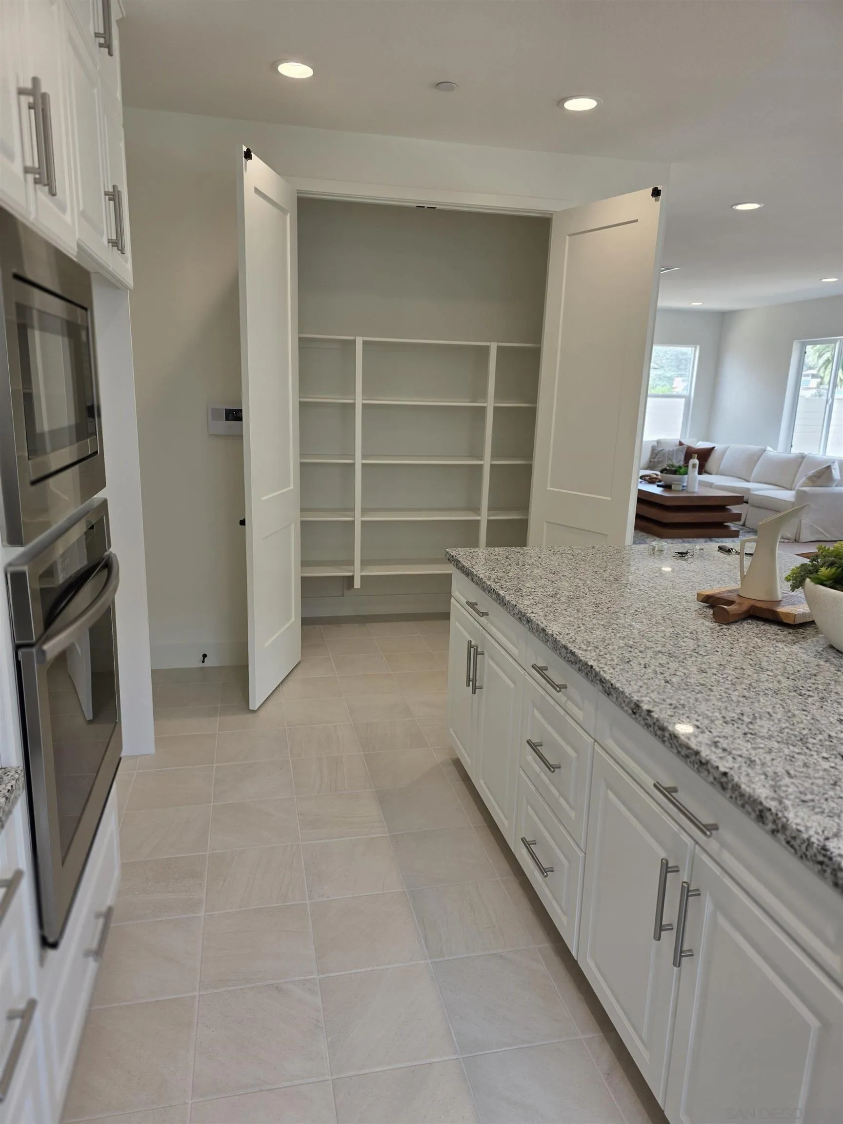 3140 Smith Place Escondido, CA 92027 - Photo 8 of 19 a large white kitchen with a sink and stainless steel appliances
