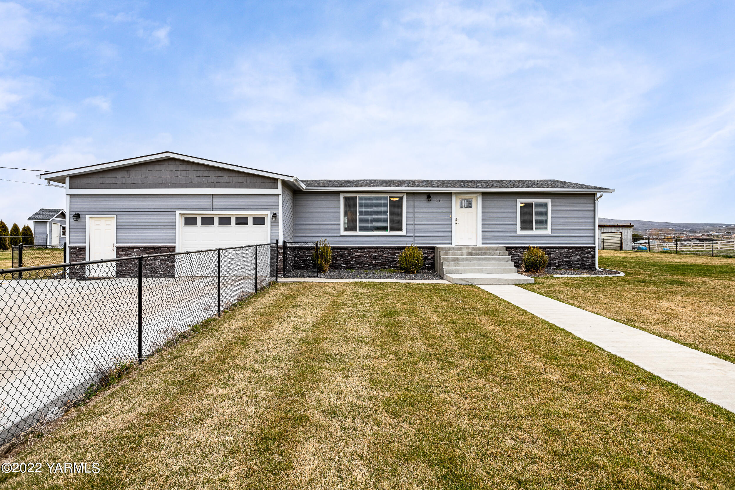 a view of house with swimming pool and yard