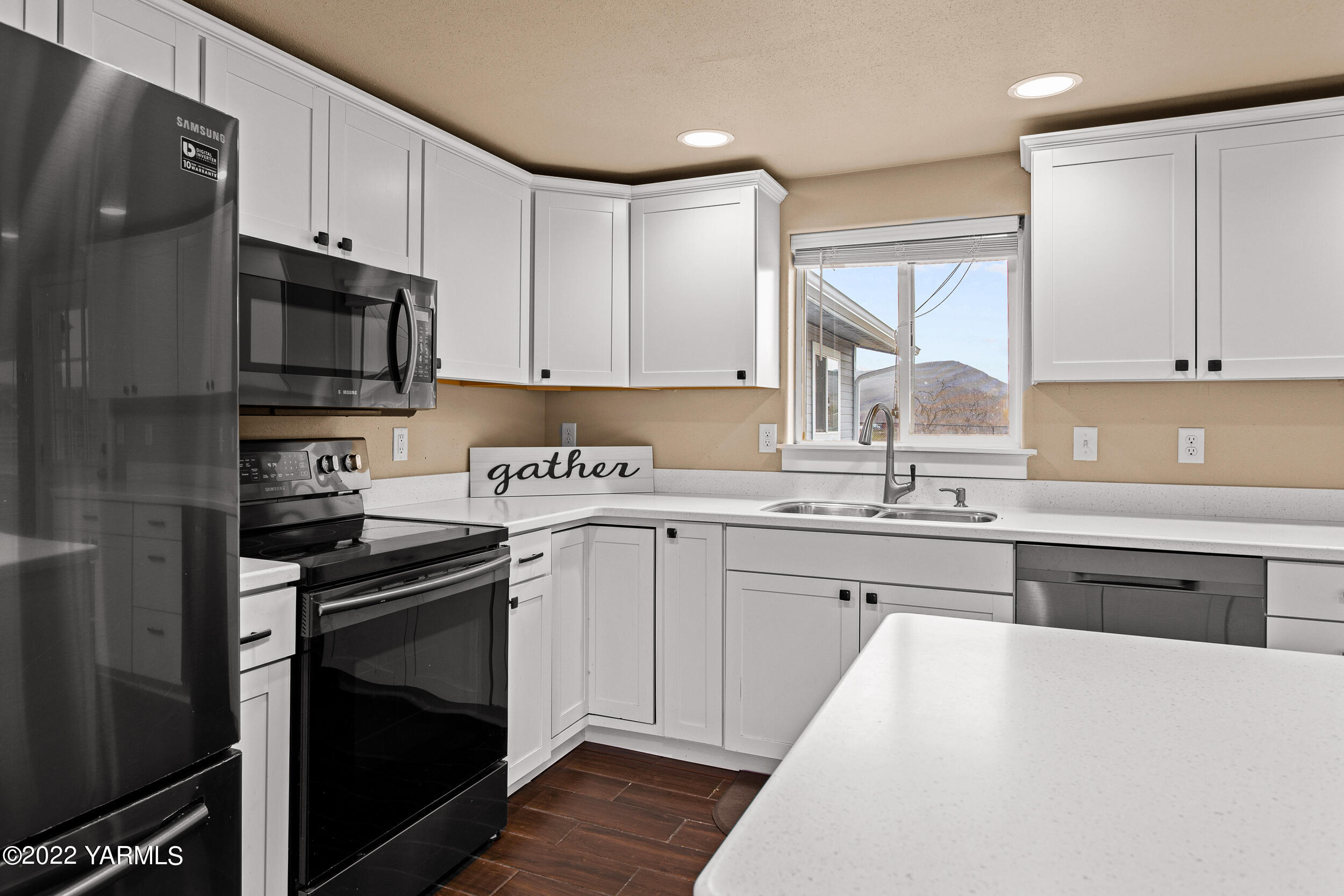 211 Wilson Road Yakima, WA 98901 - Photo 9 of 35 a kitchen with stainless steel appliances granite countertop a stove top oven a sink dishwasher and a refrigerator with wooden cabinets