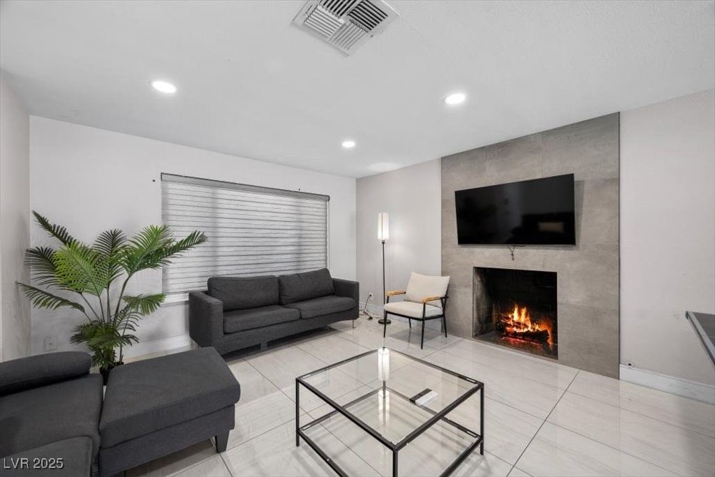 Living room with soaring ceiling features a gas fireplace!