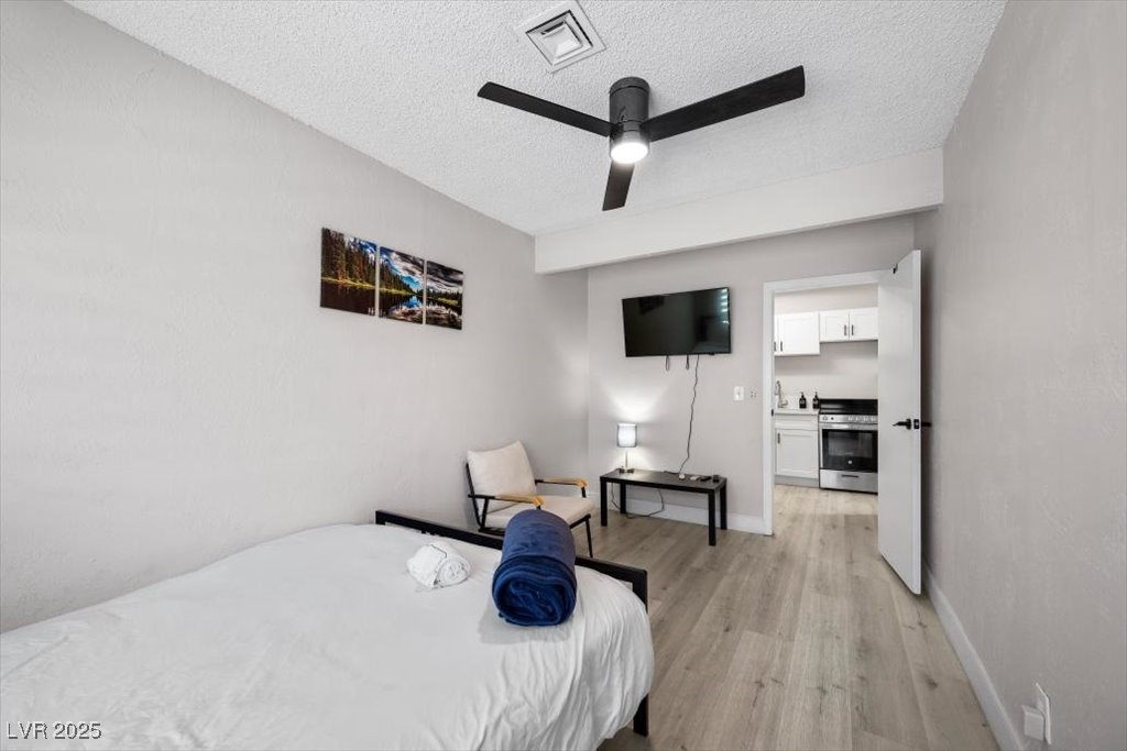 3618 Redwood Street Las Vegas, NV 89103 - Photo 32 of 57 4th bedroom features a ceiling fan and TV—perfect for relaxing evenings.