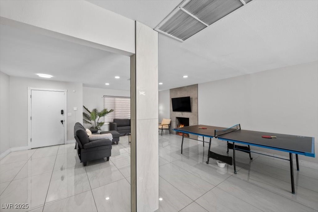 3618 Redwood Street Las Vegas, NV 89103 - Photo 6 of 57 Fully furnished and ready for fun—this vibrant living space includes a sleek ping pong table.