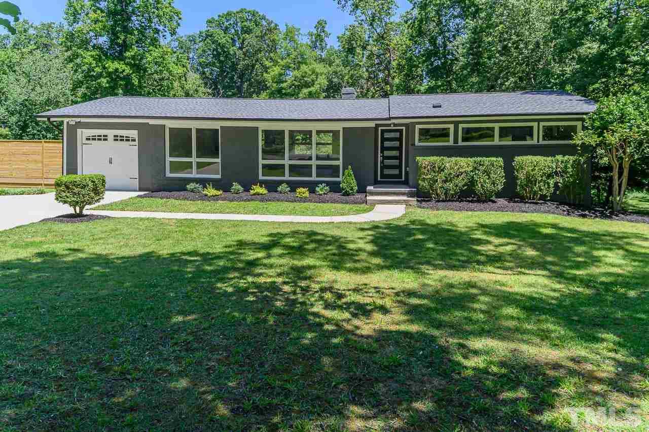 3401 Forest Road Raleigh, NC 27604 - Photo 1 of 30 a front view of a house with a yard and glass windows