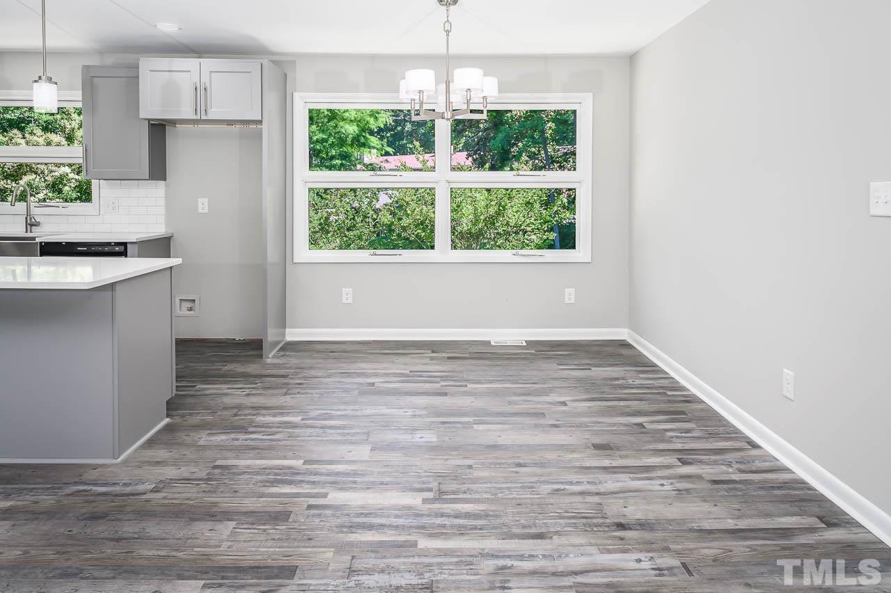 3401 Forest Road Raleigh, NC 27604 - Photo 12 of 30 an empty room with wooden floor and windows